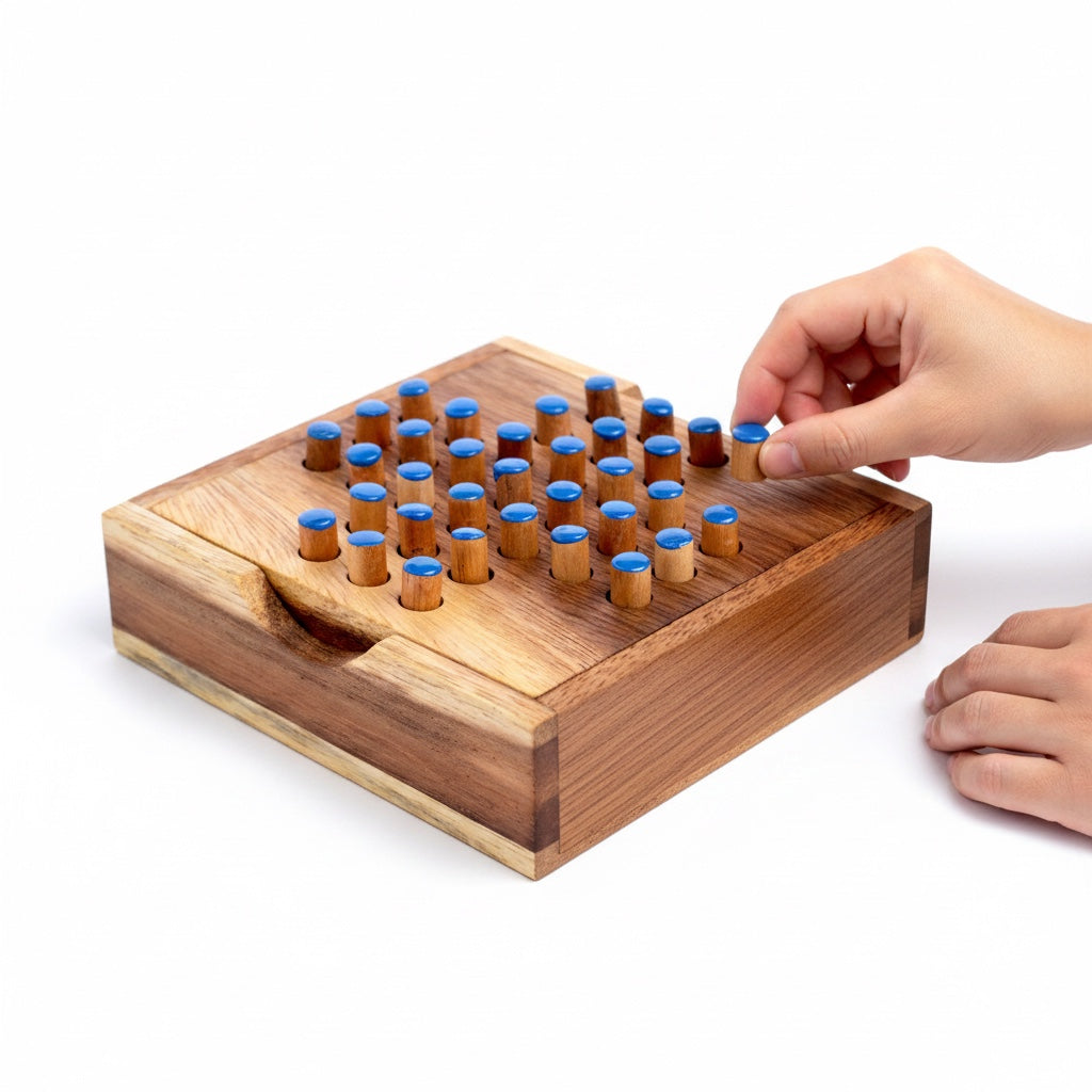 Woodtastic small wooden solitaire game box with blue pegs. Handmade from Samanea wood.